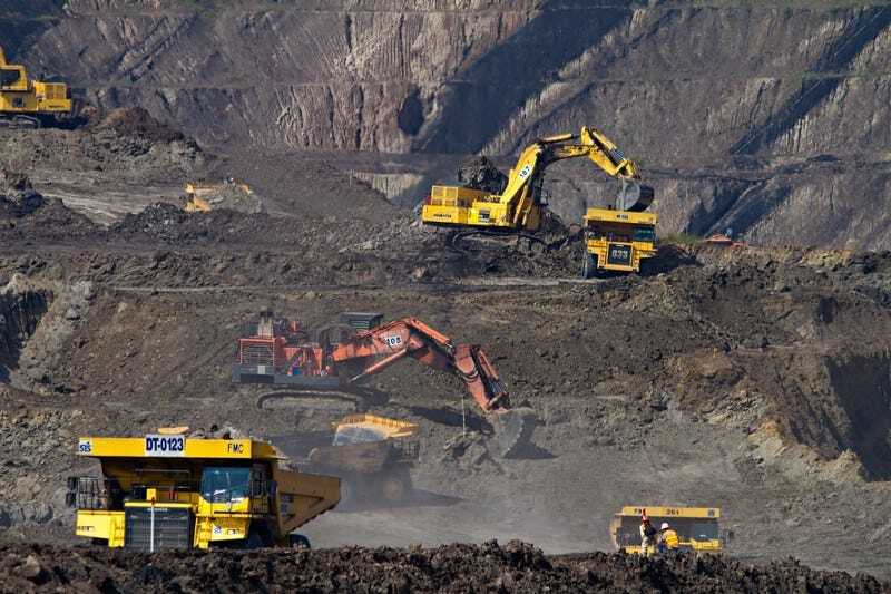 Excavators and trucks working in an open-pit mine